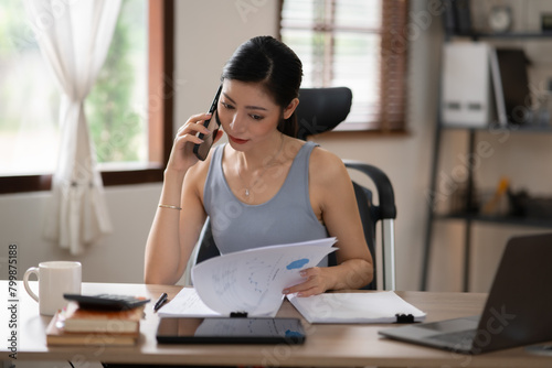 Asian woman doing activities, reading books, shopping online order through the internet at home or in the office during the holidays