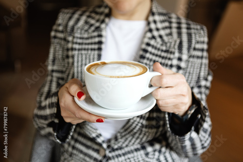Woman holding coffee cup in hands