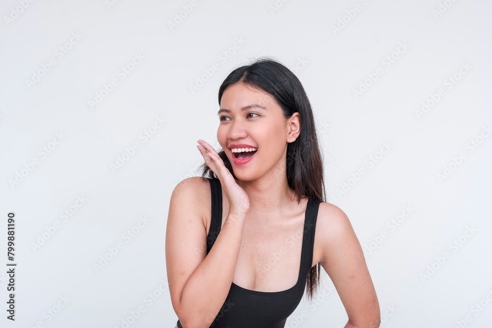 Joyful Asian woman in black bodysuit posing with a playful expression, isolated on white Joyful Asian woman in black bodysuit posing with a playful expression, isolated on white
