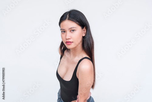 Attractive young Asian woman in a black bodysuit, posing on a white background © Mdv Edwards