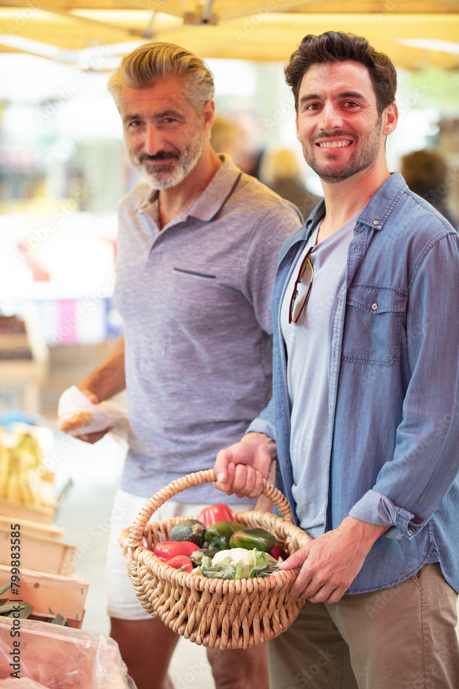 a couple of men shopping in the market a couple of men shopping in the market