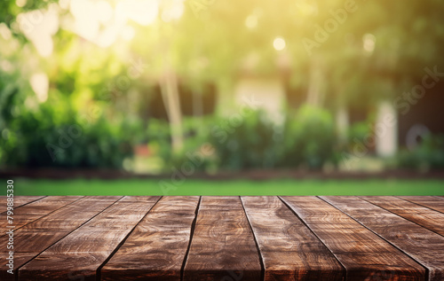 wooden table space with green home backyard view blur background for advertising template