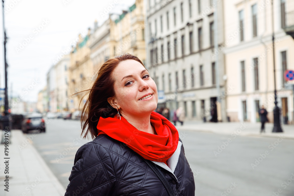 smiling young pensive daydreaming caucasian Slavonian female woman with flowing hair on street of european city St. Petersburg. architect, interior designer, businesswoman. tourism, lifestyle portrait