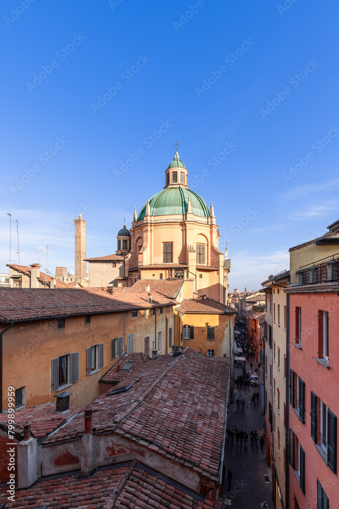 An elevated perspective captures the vibrant life of Bologna Via Pescherie Vecchie, with the Santa Maria della Vita green dome rising among rustic buildings (Vertical photo) An elevated perspective captures the vibrant life of Bologna Via Pescherie Vecchie, with the Santa Maria della Vita green dome rising among rustic buildings (Vertical photo)