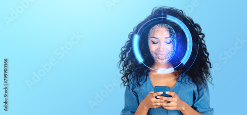 Fotografie A smiling woman with digital face recognition graphics over her face, holding a