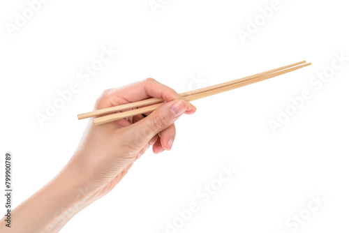 A hand holding wooden chopsticks isolated on a plain background