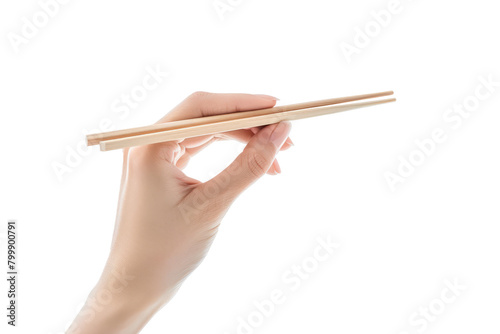 A hand holding wooden chopsticks isolated on a plain background