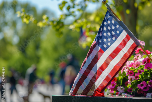 Old Glory Stands Amidst Flowers at a Memorial Day Commemoration