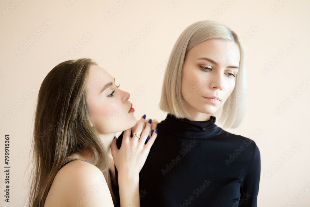 Two young women on a light background. Two young women on a light background.