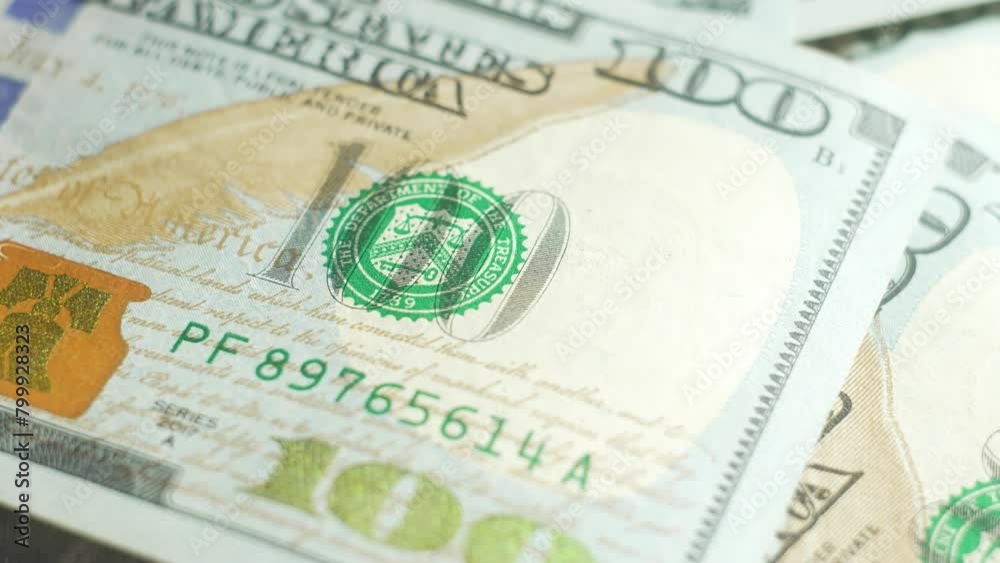 One hundred dollar bills money revolve on table. Close-up. Cash banknotes close up view. Stack of money. Dollars Bills. Business, inflation and deflation concept. Finance money background One hundred dollar bills money revolve on table. Close-up. Cash banknotes close up view. Stack of money. Dollars Bills. Business, inflation and deflation concept. Finance money background