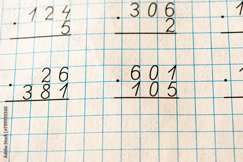 Mathematical examples on checkered paper. Calculations, numbers.