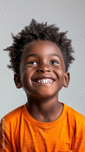 Cheerful black kid in orange t-shirt © Coosh448