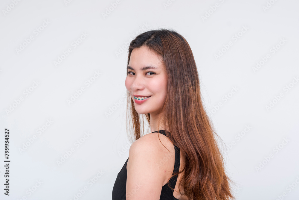 Smiling young Asian woman in a black bodysuit, isolated on a white background Smiling young Asian woman in a black bodysuit, isolated on a white background
