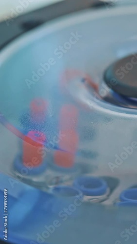 Modern centrifuge machine is working in the medical laboratory. Test tubes with blood inside the centrifuge. Close-up. Top view. Vertical video