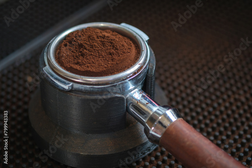 close up view of holder with coffee on coffee machine in cafe