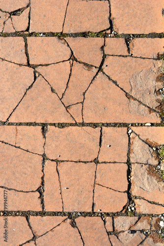Detail of cracked exterior orange floor tiles