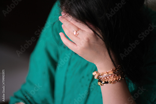 Close up shot of female hand with some beautiful gold bracelets photo