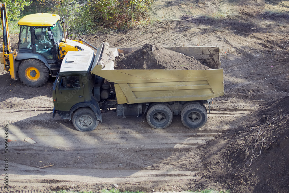 A truck with soil at the construction site, cleaning up the excavated ground at the construction site, a truck with soil at the construction site A truck with soil at the construction site, cleaning up the excavated ground at the construction site, a truck with soil at the construction site