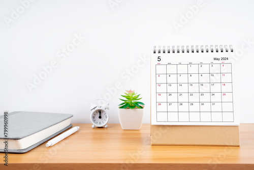 May 2024, Monthly desk calendar for 2024 year on wooden table. © gamjai