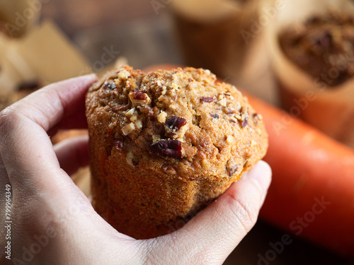 hand holding pecan carrot muffin
