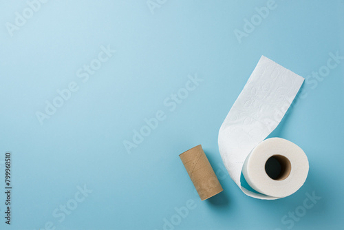 Top view of toilet paper roll on blue background