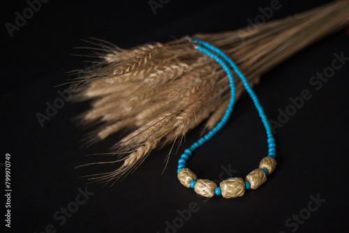 Straw necklace on a black background. Small depth of field