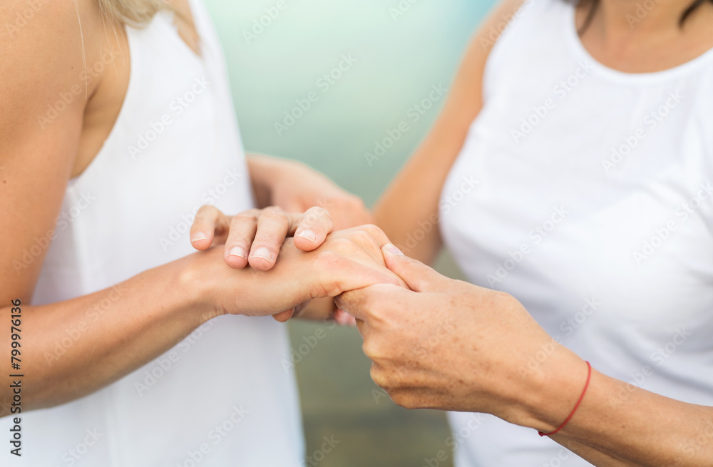 Close up of mother and daughter holding hands. Close up of mother and daughter holding hands.