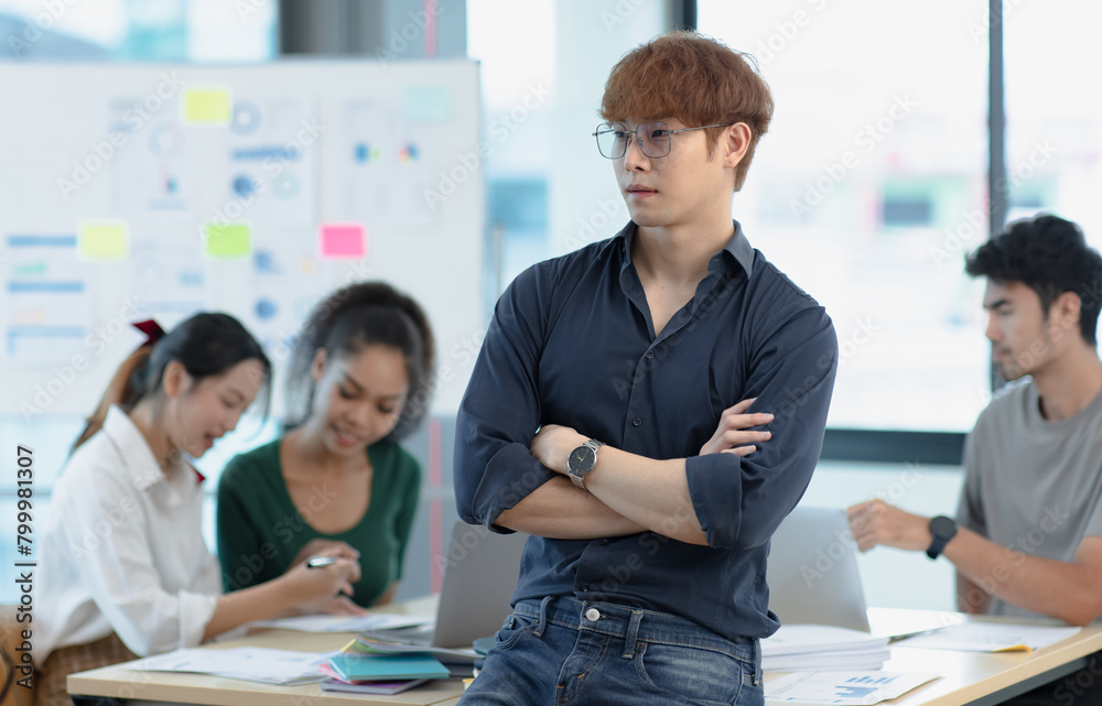 Asia young creative man in smart casual wear looking at camera in office workplace. Asia young creative man in smart casual wear looking at camera in office workplace.
