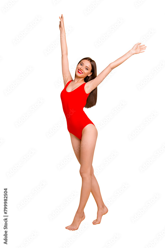 Vertical full length size photo portrait of cheerful joyful excited glad nice lovely kind adorable lady raising hands up wearing shiny swim suit having toothy smile isolated background