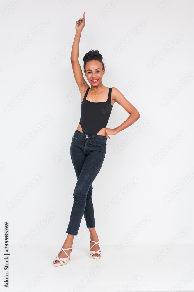 Cheerful young woman of mixed African and Asian ancestry posing in black bodysuit Cheerful young woman of mixed African and Asian ancestry posing in black bodysuit
