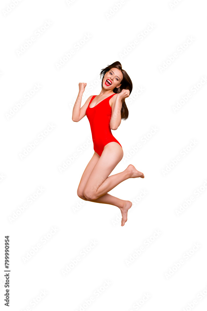Finally, holidays! Full-legs vertical portrait of girl jumping clenching her hands in fists and joyfully screaming isolated on yellow background