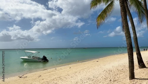 A boat on the beach at Trou aux biches beach in Mauritius with the endless blue and turquoise crystal waters of the Indian Ocean in the background (ID: 799997131)