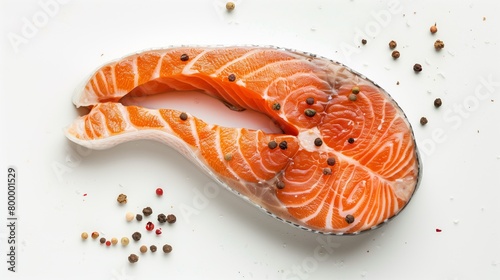 Fresh raw salmon steak garnished with peppercorns on a white background, perfect for healthy cooking.