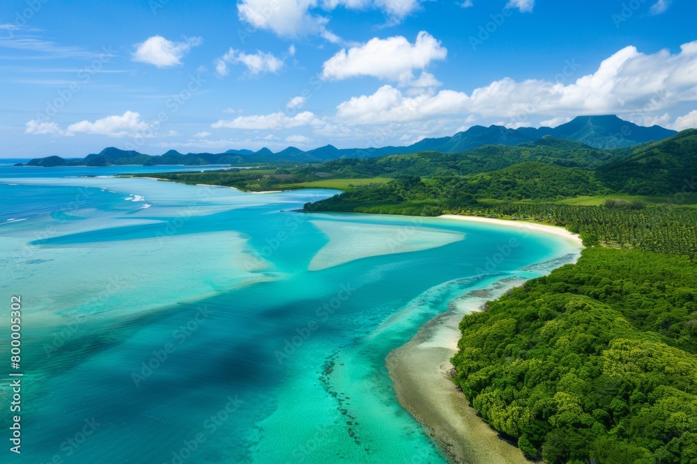 A winding coastline from above, showcasing the contrast between lush green jungle, pristine beaches