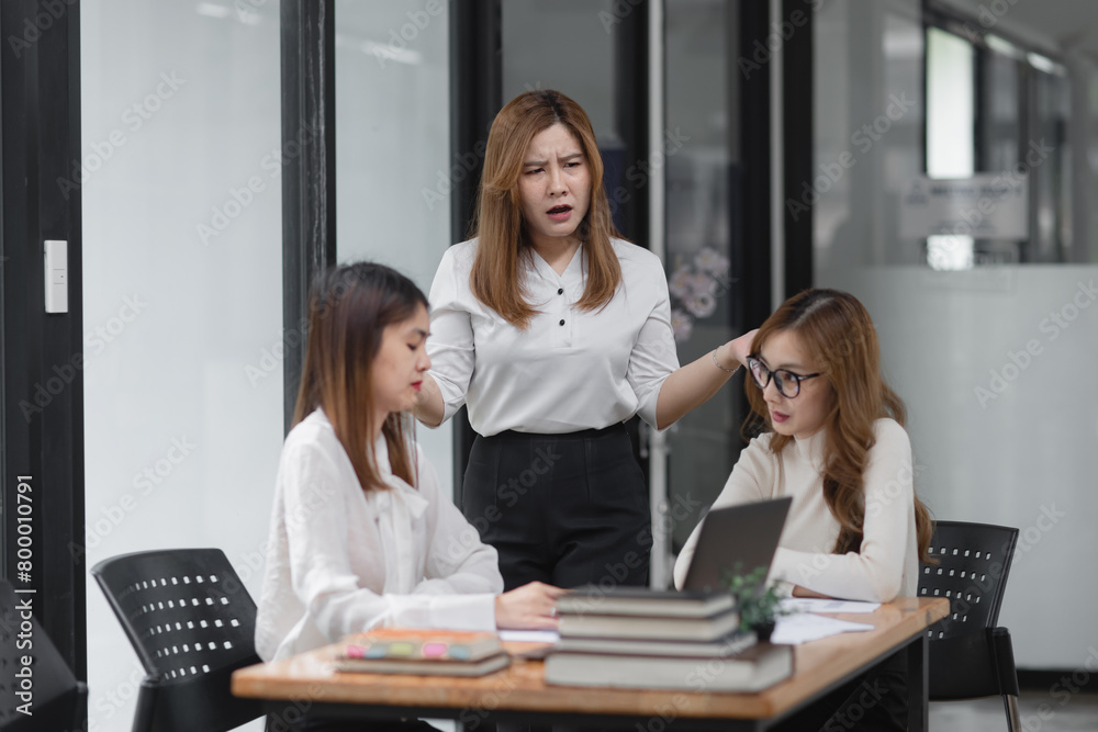 Group of young asian businesswoman working and brainstorming in workshop and analyzing marketing reports startup project infographics in the office. Group of young asian businesswoman working and brainstorming in workshop and analyzing marketing reports startup project infographics in the office.