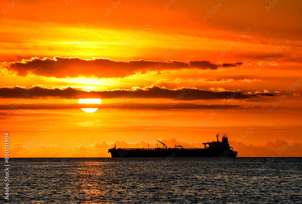 Port Louis, Port Louis district, Mauritius, Mascarene Islands, Africa - sunset over Indian Ocean with distant container ship seen from Tombeau Bay located close to Port Louis harbour