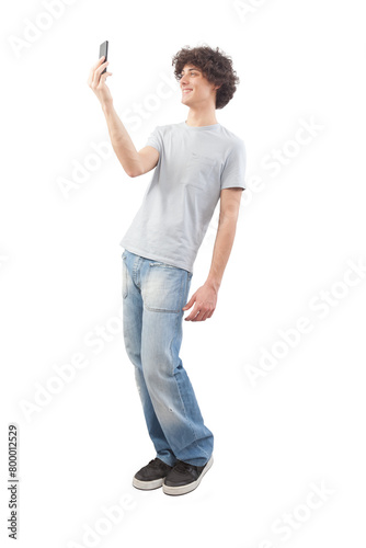 Young happy smiling handsome man using his smartphone, taking a selfie isolated against a white background, full body image
