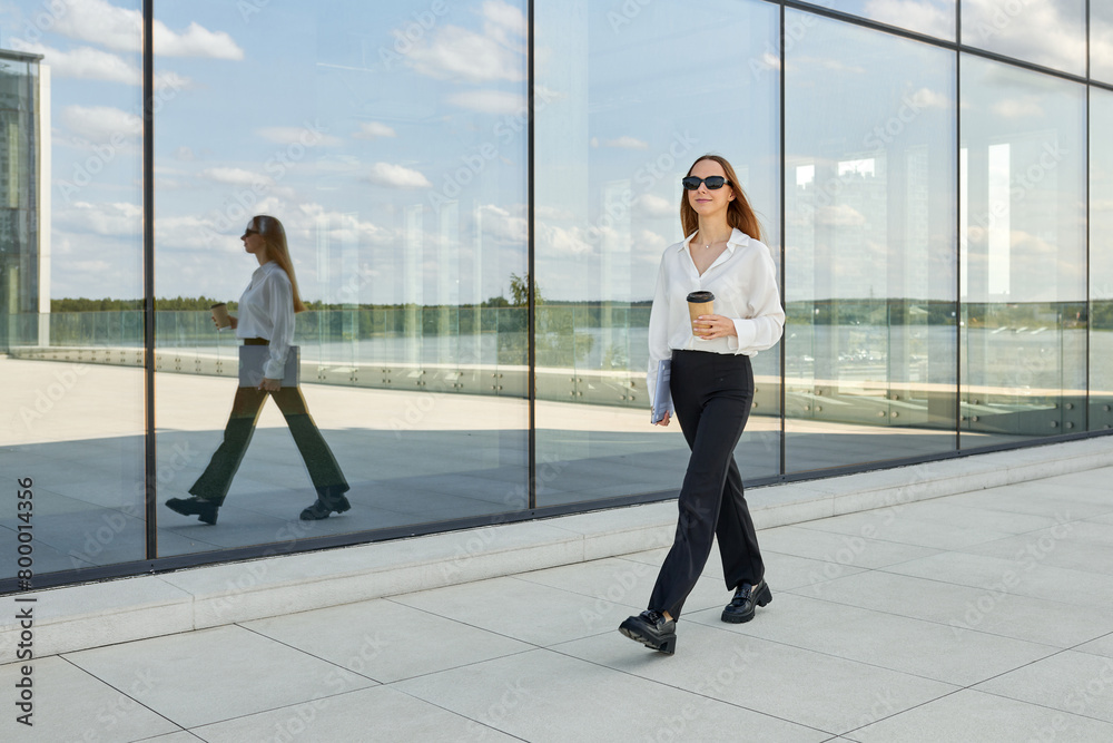 This is what an office employee who is in a hurry to work looks like. Stylish woman in a white shirt and black pants This is what an office employee who is in a hurry to work looks like. Stylish woman in a white shirt and black pants