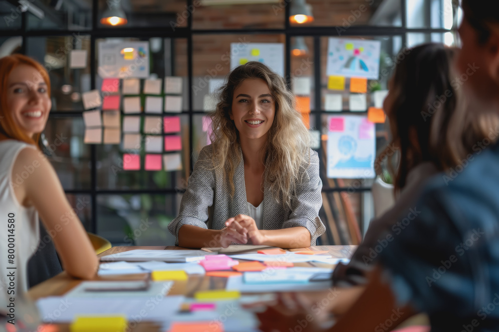 Happy Latin project manager woman holding brainstorming with colleagues in the office boardroom.