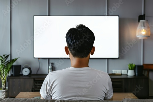 App mockup asian man in his 20s in front of an smart-tv with a fully white screen