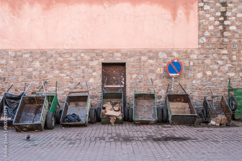 A row of empty carts against a wall in Marrakesh, Morocco.  The carts are used to carry goods into the narrow, widing streets of the Medina and Souk.