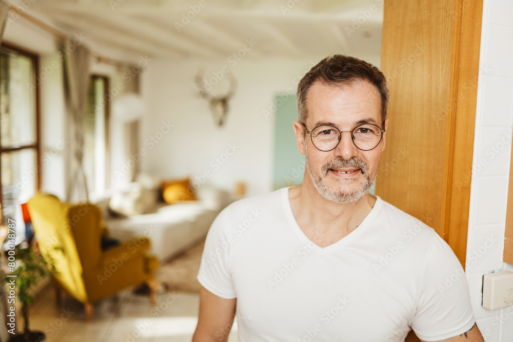 Smiling Mature Man in Doorway of His Living Room Smiling Mature Man in Doorway of His Living Room