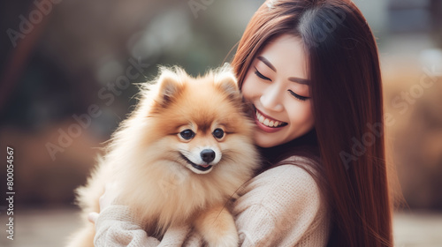 Pomeranian dog hug by a beautiful woman © HappyPICS