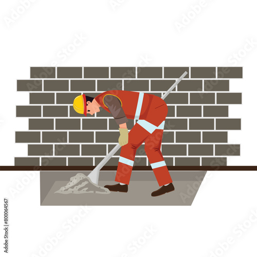 Worker digging with a shovel next to the brick wall. Construction concept