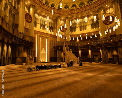 People are praying at the Taksim mosque at night photo
