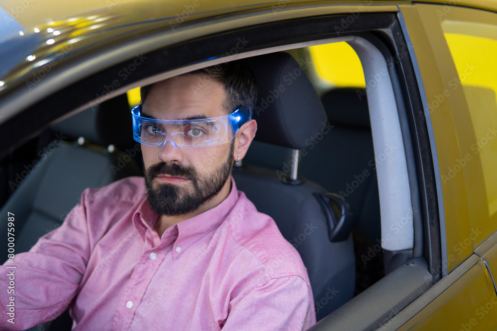 Man wearing smart glasses and sitting inside car Man wearing smart glasses and sitting inside car