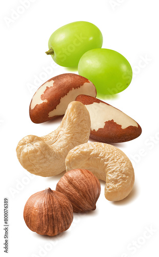 Cashew, hazelnut, brazil nuts and green grapes isolated on white background. Vertical layout © kovaleva_ka