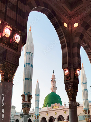 General view green dome and Moorish pattern arches of Nabawi mosque in Al Madinah, Kingdom of Saudi Arabia.