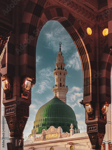 General view green dome and Moorish pattern arches of Nabawi mosque in Al Madinah, Kingdom of Saudi Arabia.