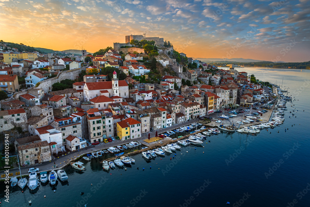 Sibenik, Croatia - Aerial panoramic view of the mediterranean old town of Sibenik on a sunny summer morning with Saint James Cathedral, Fortress of Saint Michael and dramatic golden sunrise